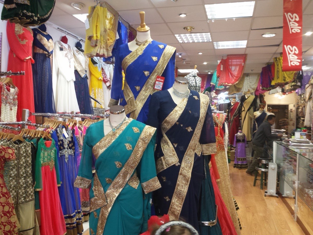 A shop of colourful saris and occasion fabrics at Chrisp Street Market, Poplar E14