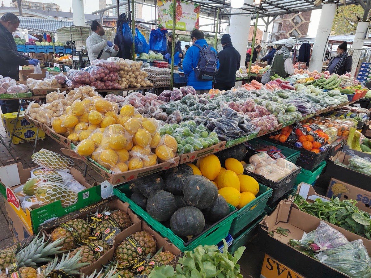 Colourful fruit and vegetable stall piled with produce at Chrisp Street Market, Poplar E14